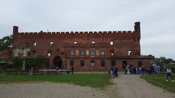 Сам замок, на фоне группа туристов.