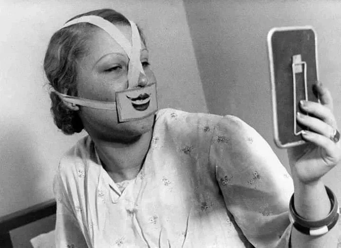 A woman wearing a special mask to combat depression. Budapest, 1937 - Depression, Mask, Black and white photo