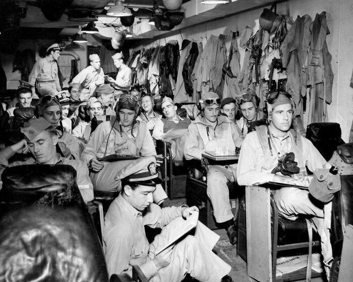 US naval aviators aboard an aircraft carrier await pre-flight briefing, 1944 - The photo, Black and white photo, US Army, 1944, The Second World War