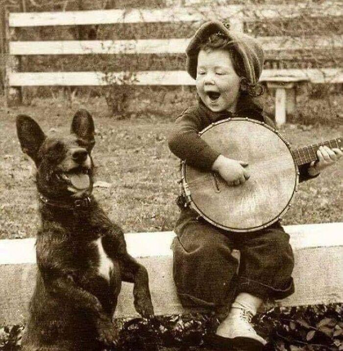 Boy playing banjo with his dog, 1900 - The photo, Boy, Dog