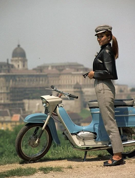 Fashion catalogue shoot on Gellert Hill, Budapest, 1967. The girl is wearing a faux leather coat, next to her is a Czechoslovakian JAWA 50 - The photo, Budapest, Girls, Scooter, PHOTOSESSION, 1967